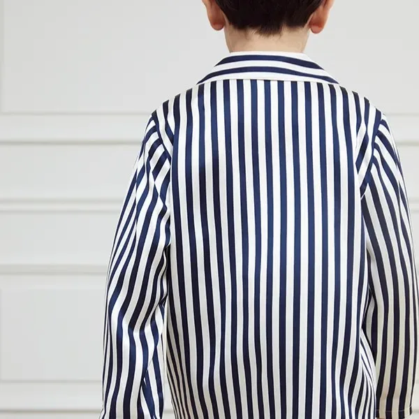 Detail view of custom kids silk pajama set with notched collar, button-front top, long sleeves, full-length pants, and relaxed fit for private label