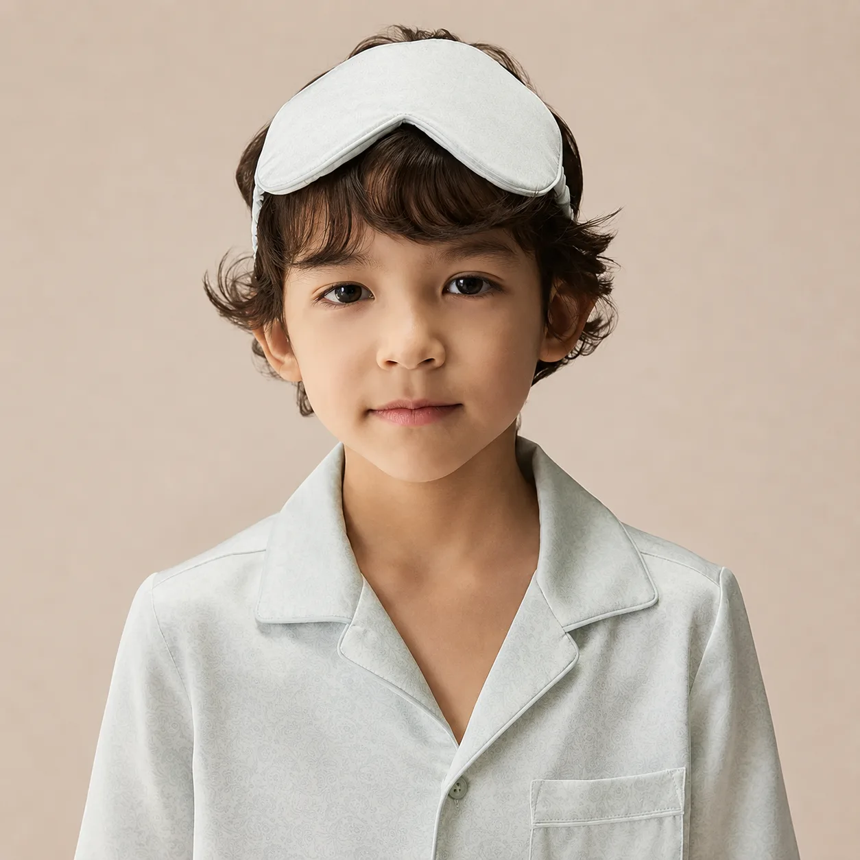 Contoured kids sleep mask with light padding, piped edge seams, and an elastic headband for private label fit review
