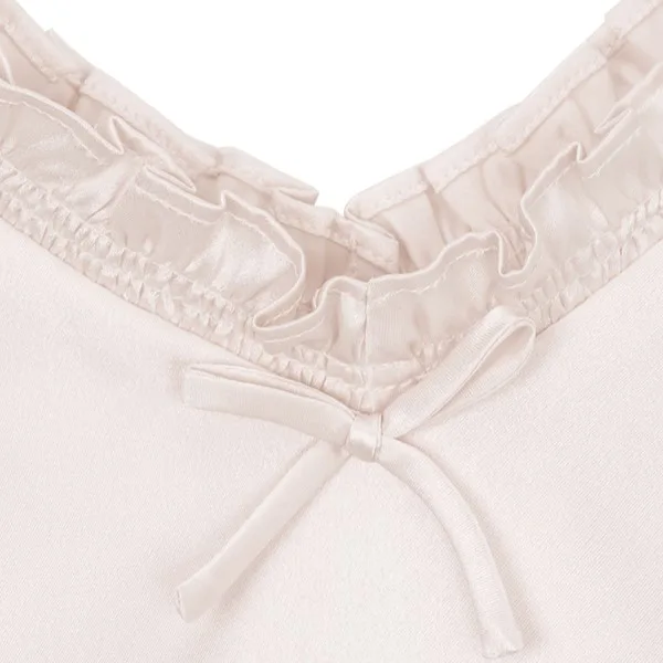 Detail of private label kids silk garment neckline with gathered seam, ruffled edge, and front tie closure for adjustable comfort