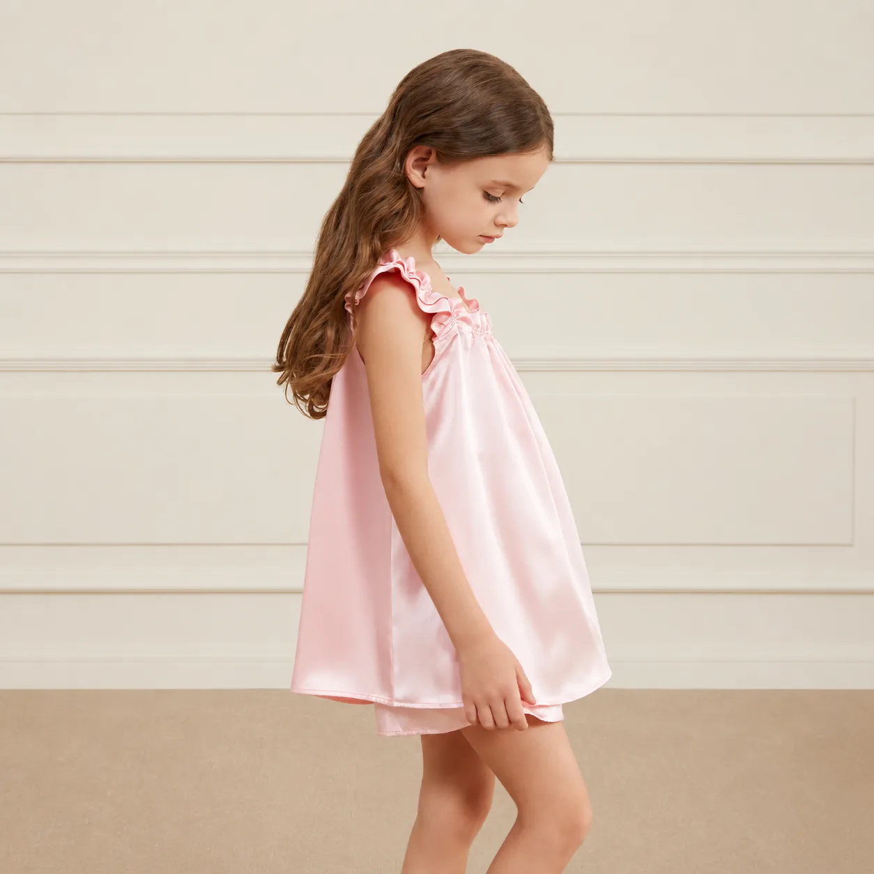 Custom kids silk dress style with loose A-line construction, ruffled shoulder straps, gathered neckline, and finished hem seams for comfortable