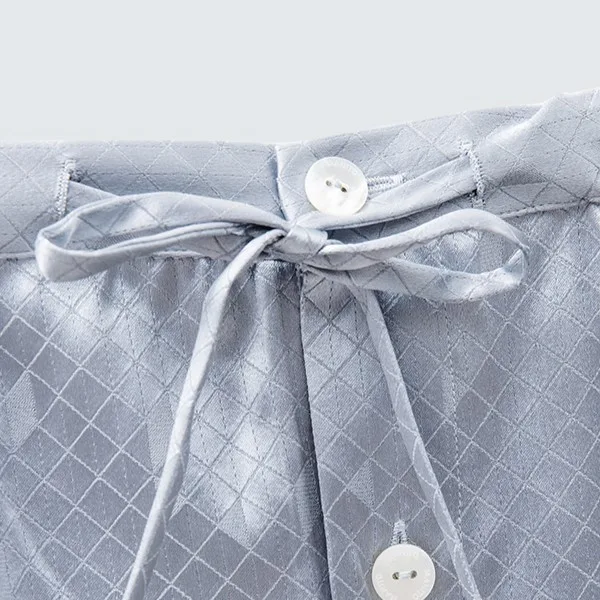 Close-up of custom kids pajama set waistband with tie closure, button placket, and finished seams for adjustable private label fit