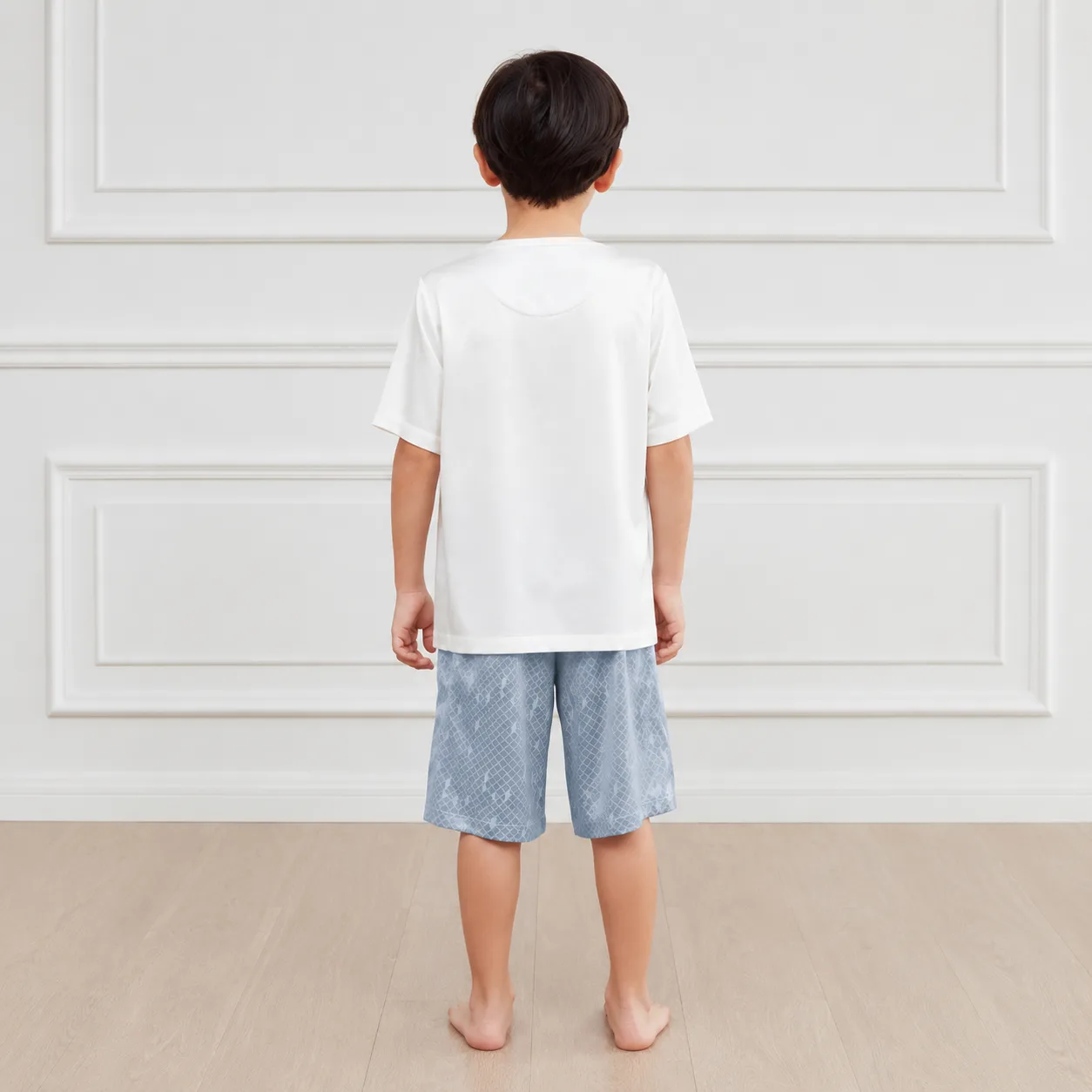 Back detail of kids private label loungewear set showing relaxed short-sleeve top fit, straight bottom hem, roomy shorts cut, and clean edge finishing
