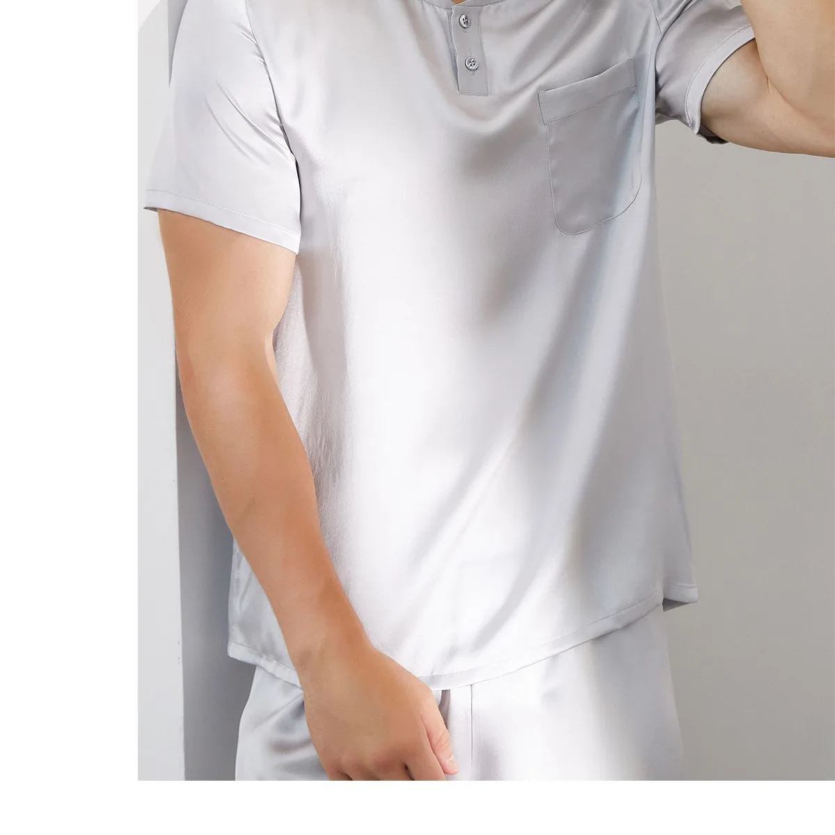 Detail view of private label short sleeve pajama top with partial button placket, chest pocket, finished sleeve edge, and curved hem for relaxed
