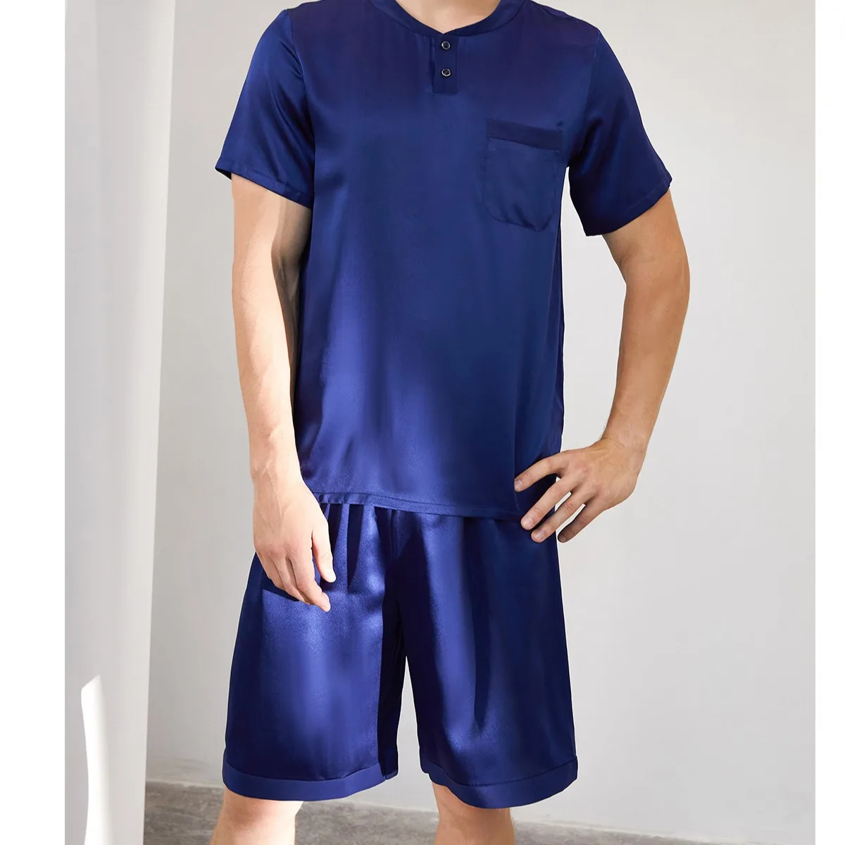 Detail view of custom silk pajama set with short-sleeve button-placket top, relaxed shorts, stitched hems, and easy-fit construction for private label