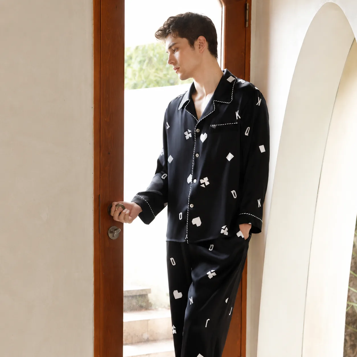 Private label pajama set construction with relaxed long sleeve top, notched collar, button front closure, contrast piped edges, and easy-fit pants for