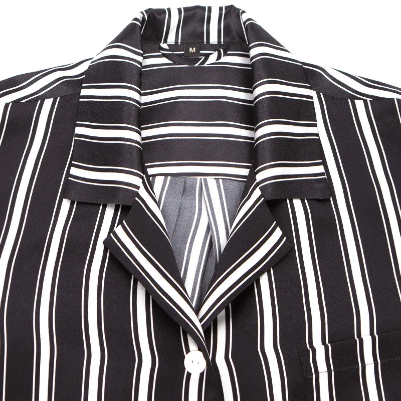 Detail view of private label pajama top construction with notched lapel collar, button front closure, chest pocket, and clean stitched seams for
