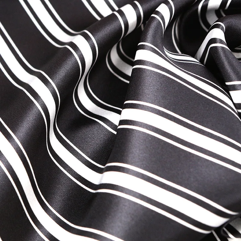 Close-up drape detail of custom silk pajama fabric for private label sleepwear, showing soft fold structure for comfort and fit review