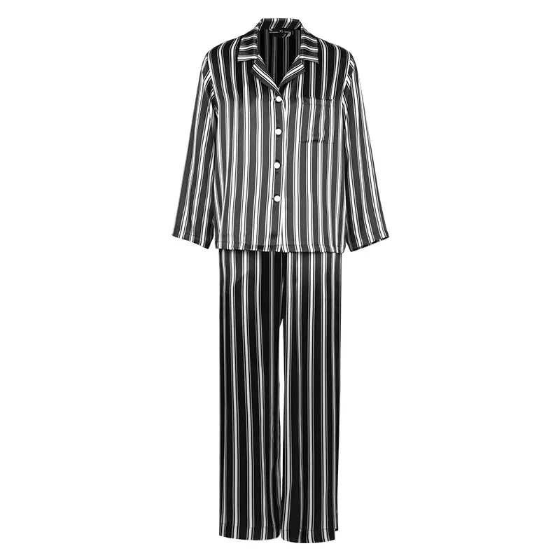 Two-piece custom silk pajama style with notched collar, button-front top, three-quarter sleeves, chest pocket, and relaxed straight-leg pants for