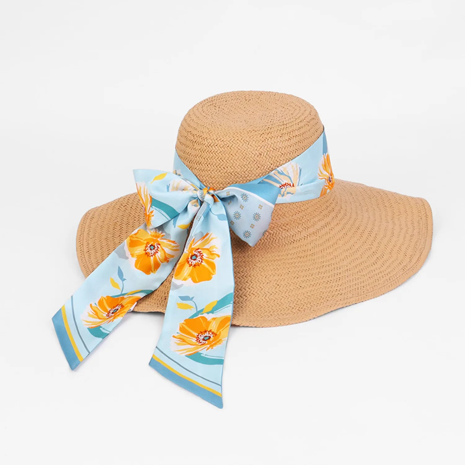 Detail view showcasing the elegant construction of a custom silk scarf tied as a decorative band on a sun hat, highlighting the soft drape and smooth