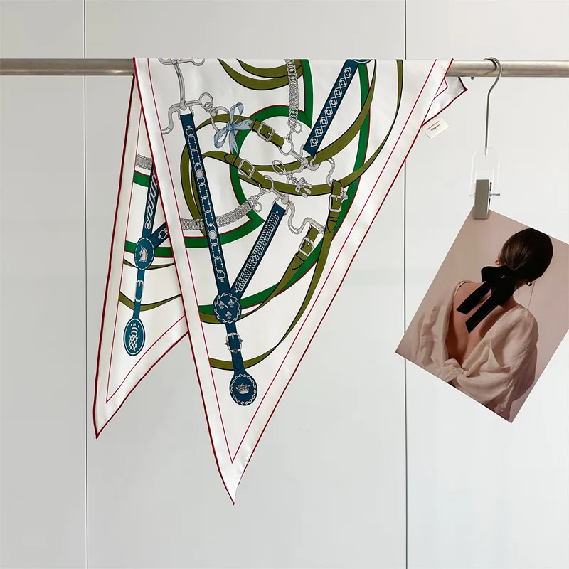 Detail view of a custom silk scarf showcasing a unique triangular shape and elegant edge finishes tailored for private label clients