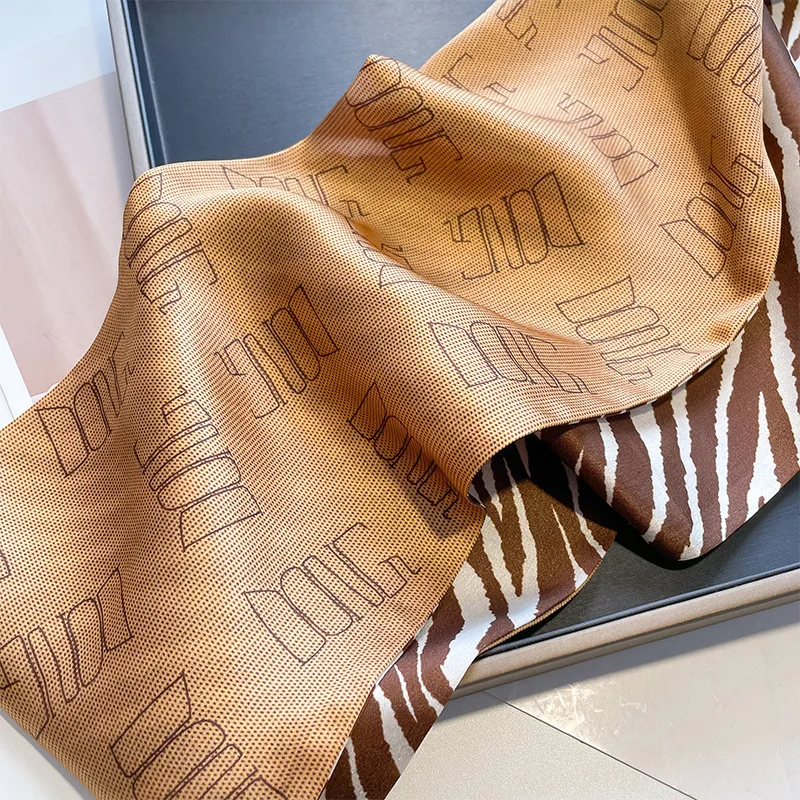 Detail view showcasing the construction and edge finish of a premium custom silk scarf, highlighting the fluid drape and comfortable fit for private