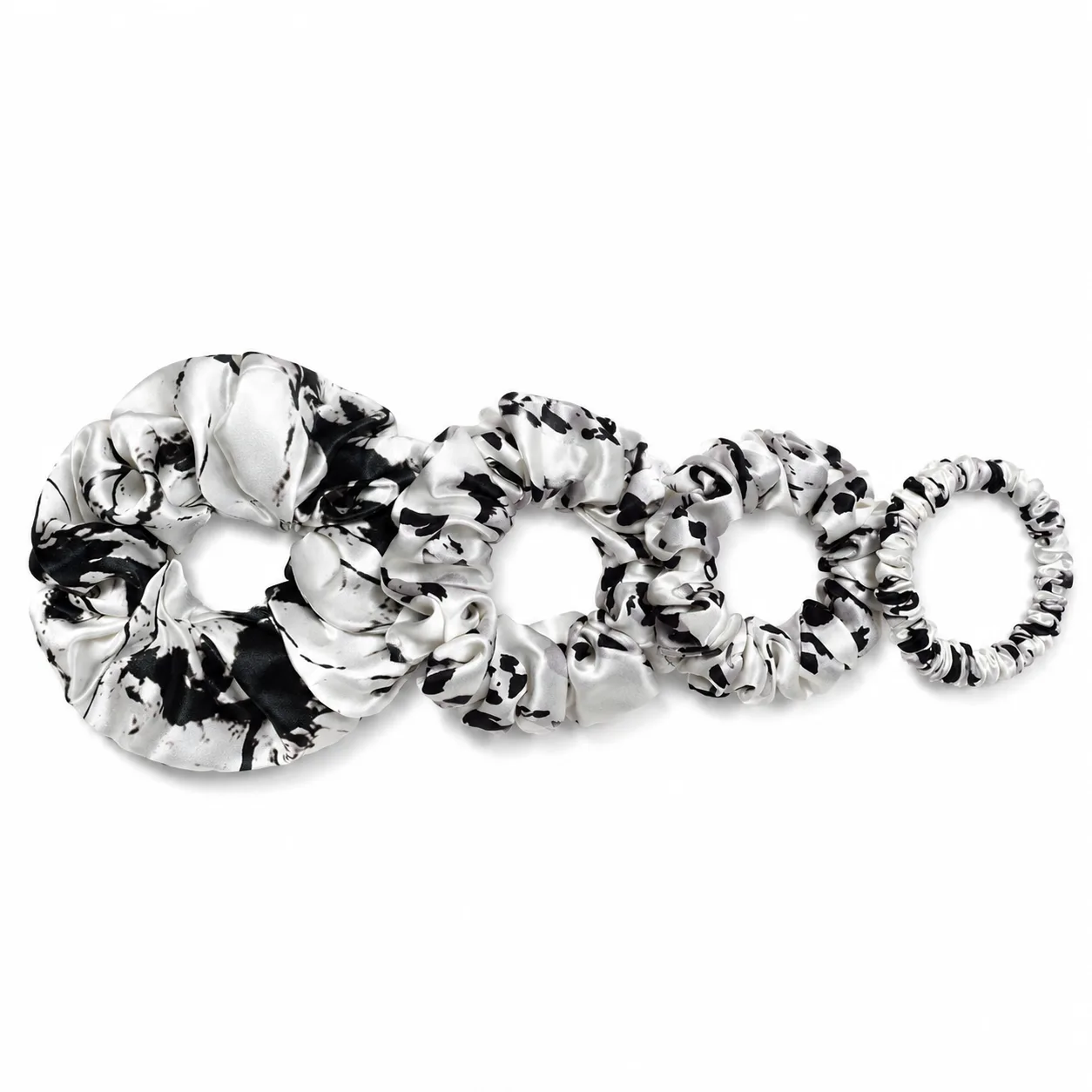 Detail view of custom silk scrunchies showcasing varied sizes and construction features, ideal for private label brands in the hair accessory market