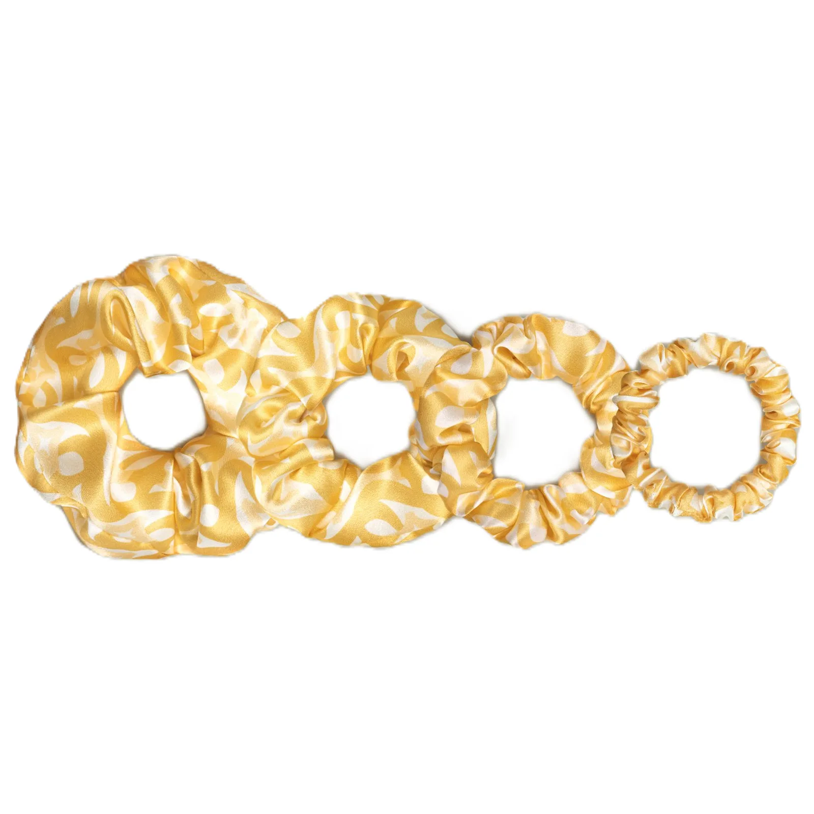 Detail view of custom silk scrunchies showcasing varied sizes and shapes for private label clients, highlighting the construction and comfort features
