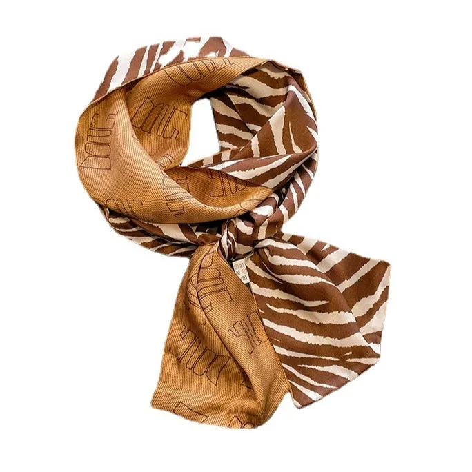 Custom double-sided caramel zebra stripe and letter-repeat mulberry silk skinny scarf for private label fashion and gift brands