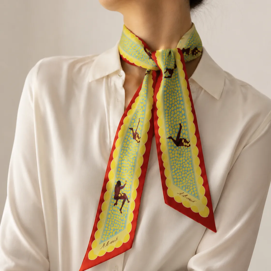 Lifestyle image showcasing the Equestrian Print Silk Skinny Scarf, tailored for private label brands in the beauty and fashion sectors