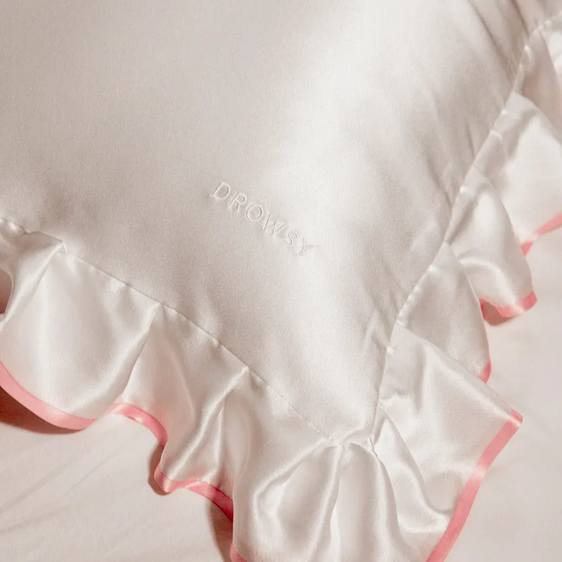 Detail view showcasing the construction of a custom silk pillowcase, featuring ruffled edges and a delicate finish designed for brand customization