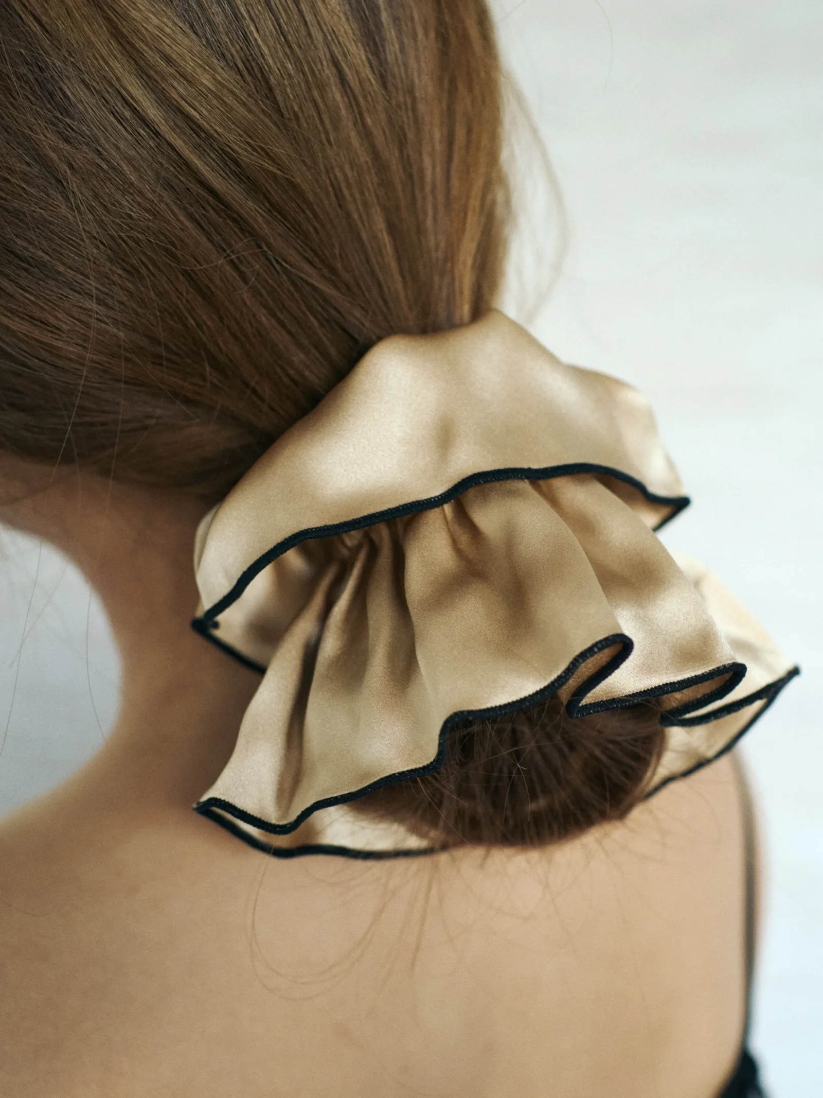 Lifestyle image showcasing custom silk scrunchies, ideal for private label hair accessory and gift set brands