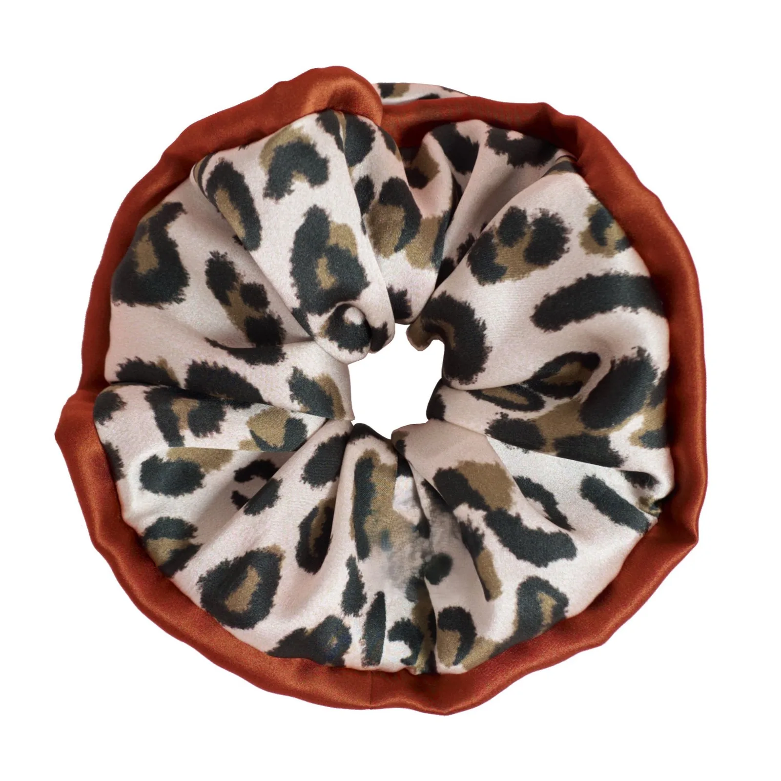Close-up image of a custom silk scrunchie in a leopard print design, showcasing premium fabric ideal for private label branding