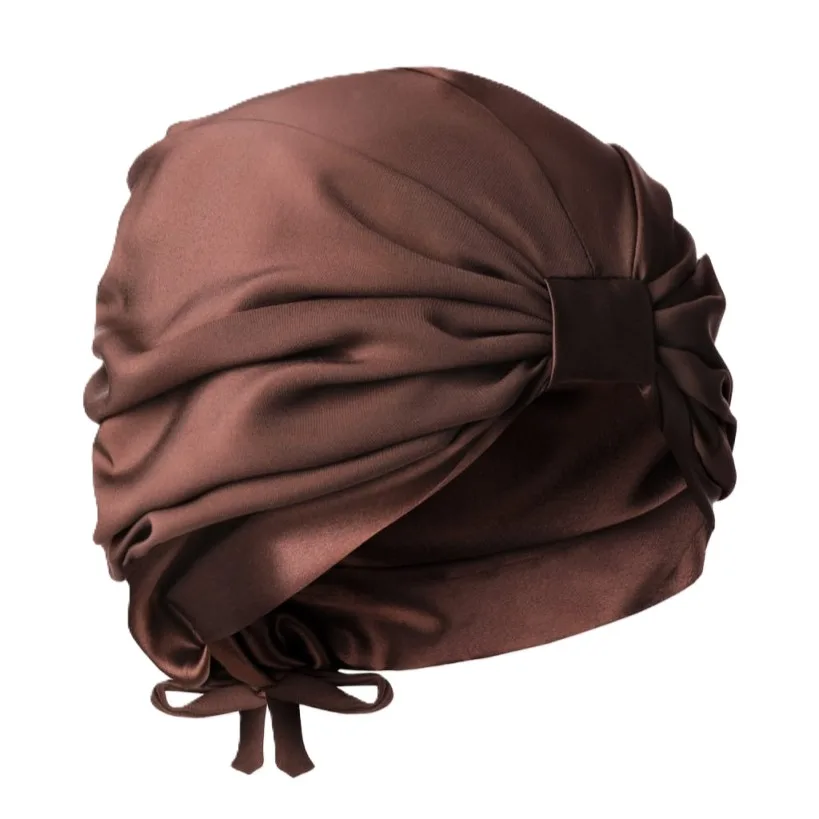 Detail view showing the structured design and adjustable fit of a custom silk turban, highlighting its comfortable wrap and tie closure for secure