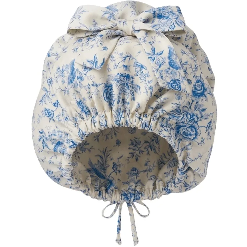 Detail view showcasing the construction of a custom silk sleep cap with gathered elastic edges and a bow detail for secure and comfortable fit, ideal