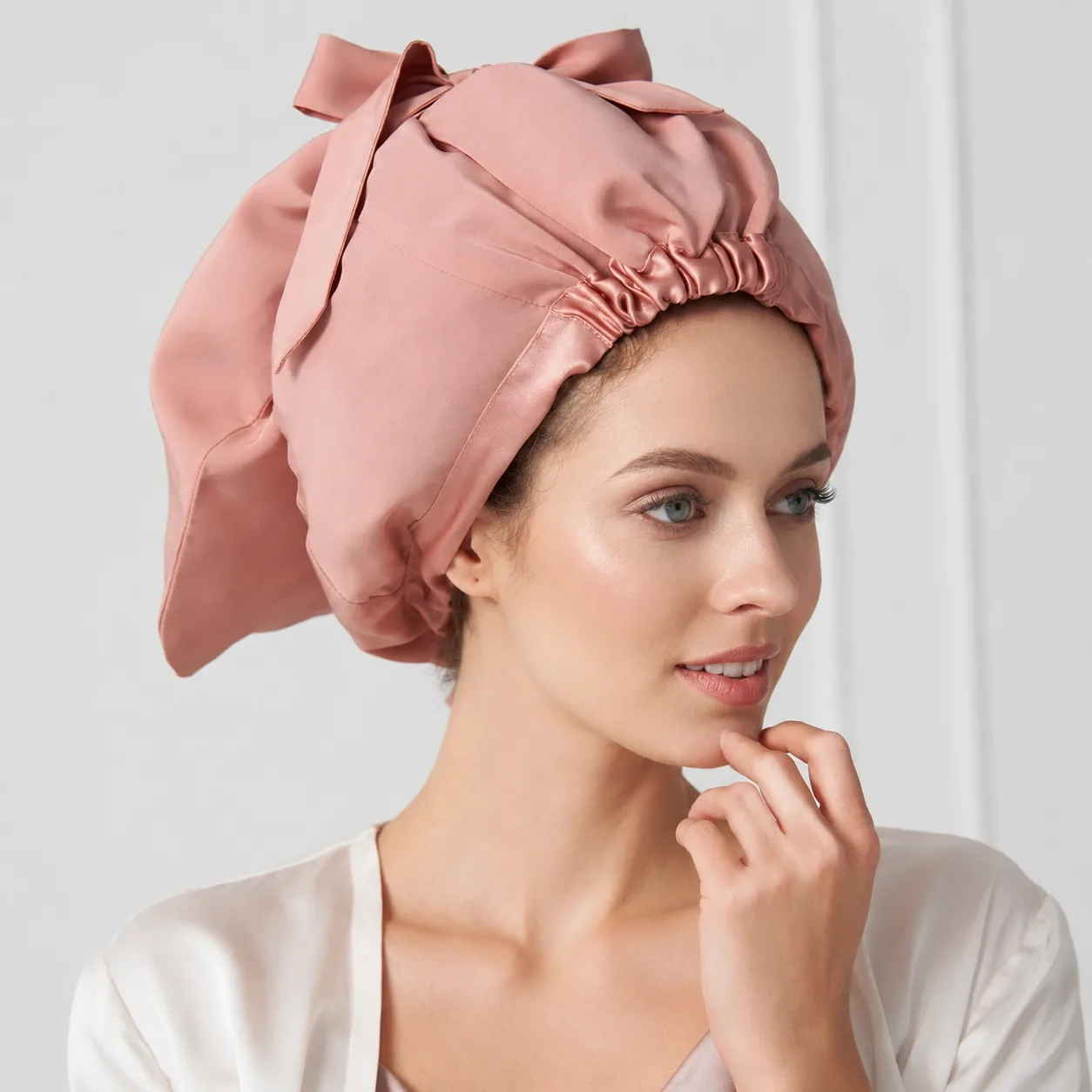 Detail view of a custom silk sleep cap featuring an elasticized band for a secure fit and luxurious soft silk construction, ideal for promoting hair