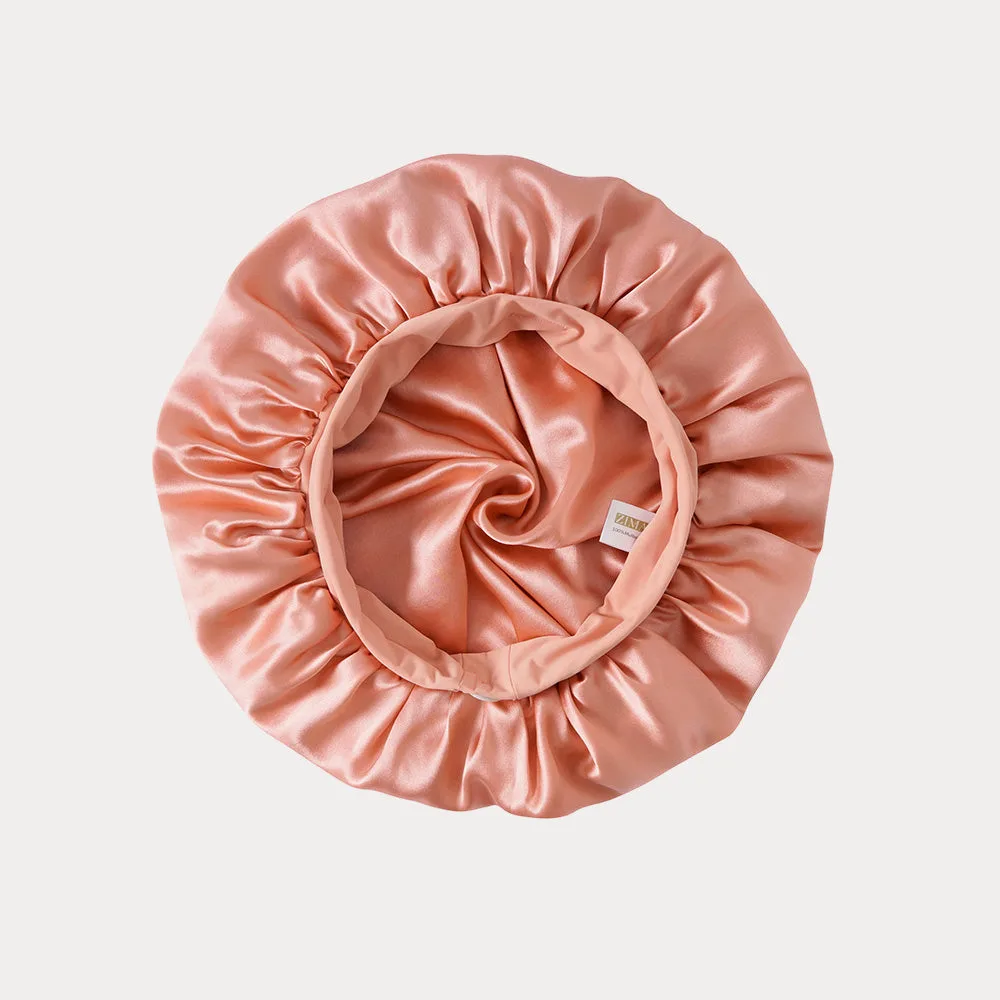 Detail view of a custom silk sleep cap featuring a gathered edge for a secure fit, designed for optimal comfort during hair care routines for beauty