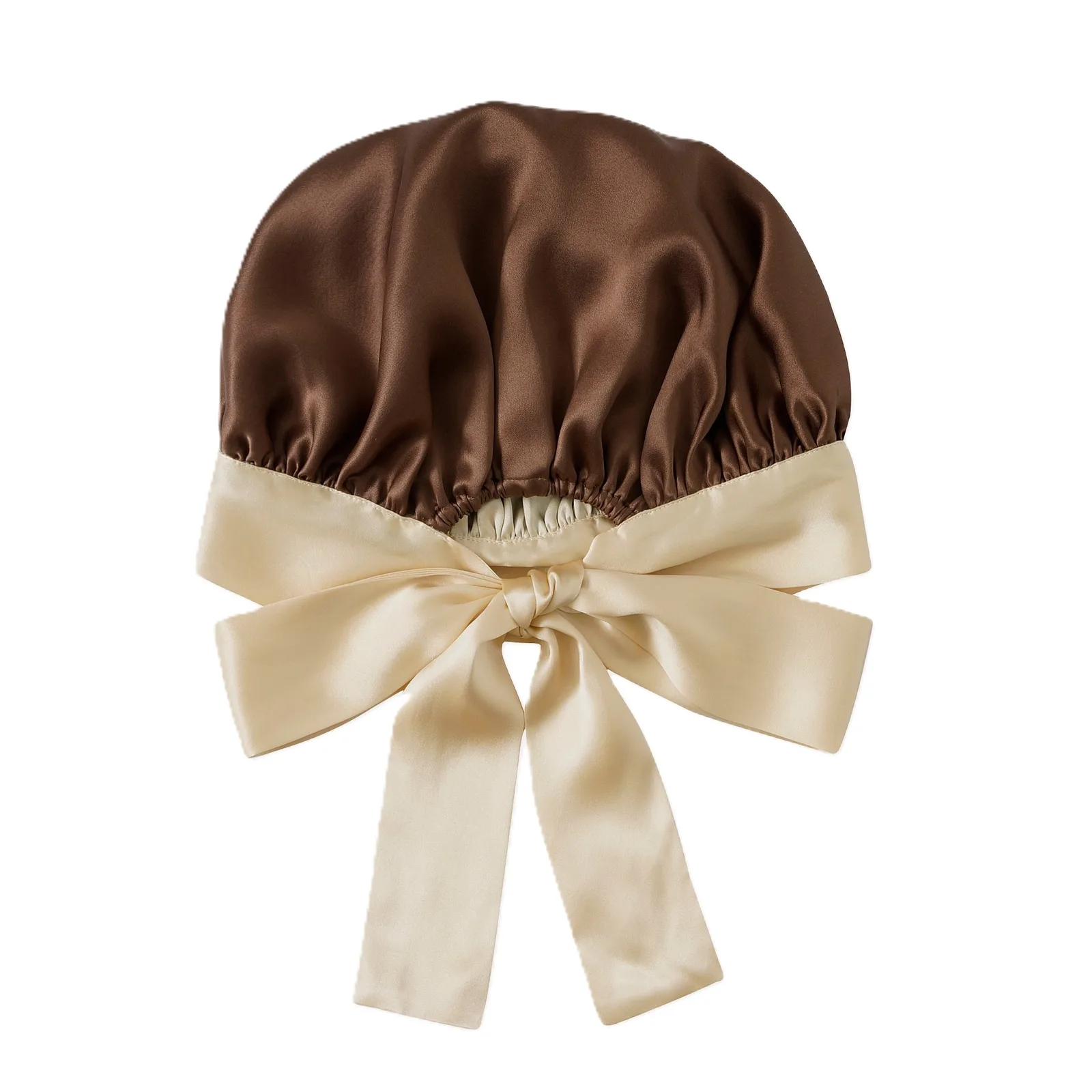 Detail view of a custom silk sleep cap featuring a gathered design and satin ribbon ties, designed for private label clients in the hair care and