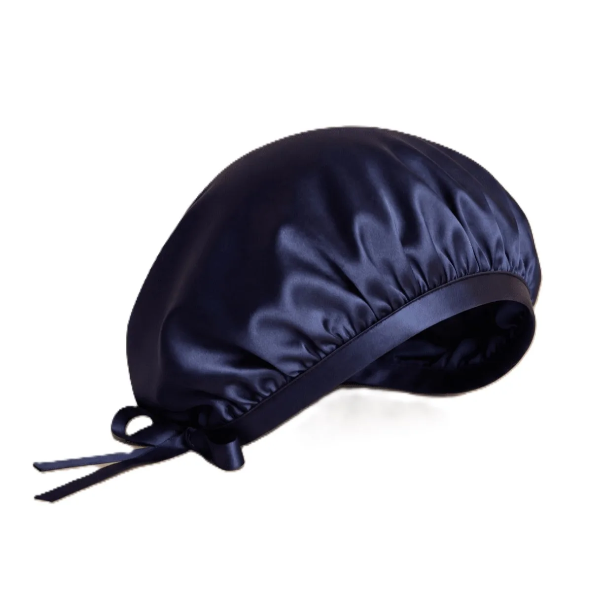 Detail view showcasing the structured design and plush fit of a custom silk sleep cap, featuring a secure band and tie for optimal comfort tailored