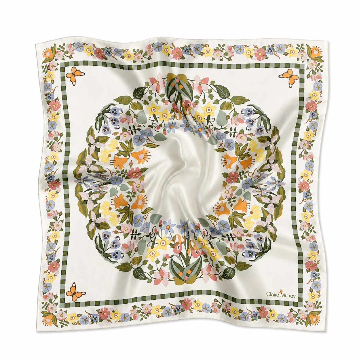 Detail view of a custom silk scarf featuring floral designs and a bordered edge, showcasing soft drape and luxurious finish for private label clients