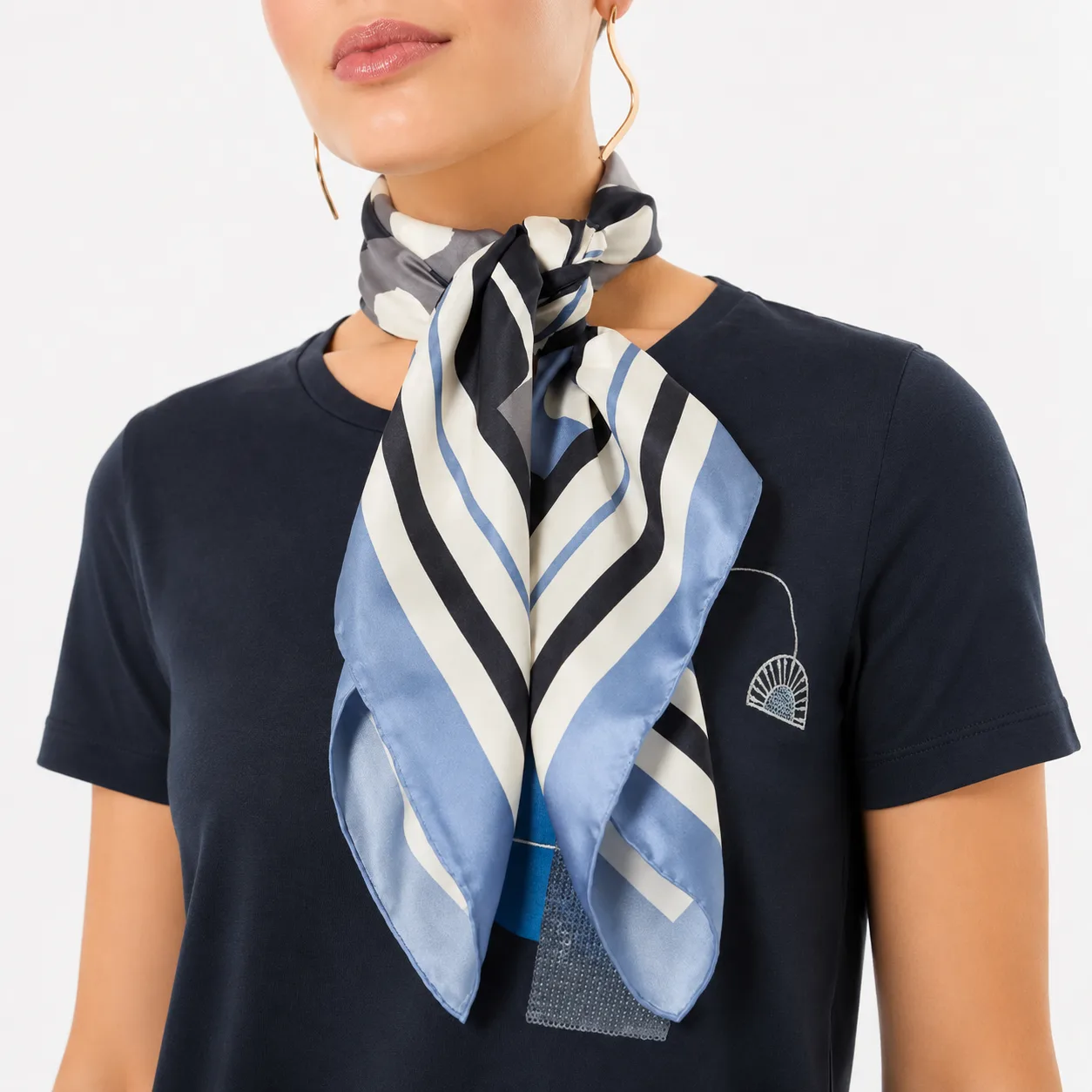 Detail view of a custom silk scarf designed for private label fashion and gift brands, showcasing its tailored construction and elegant design