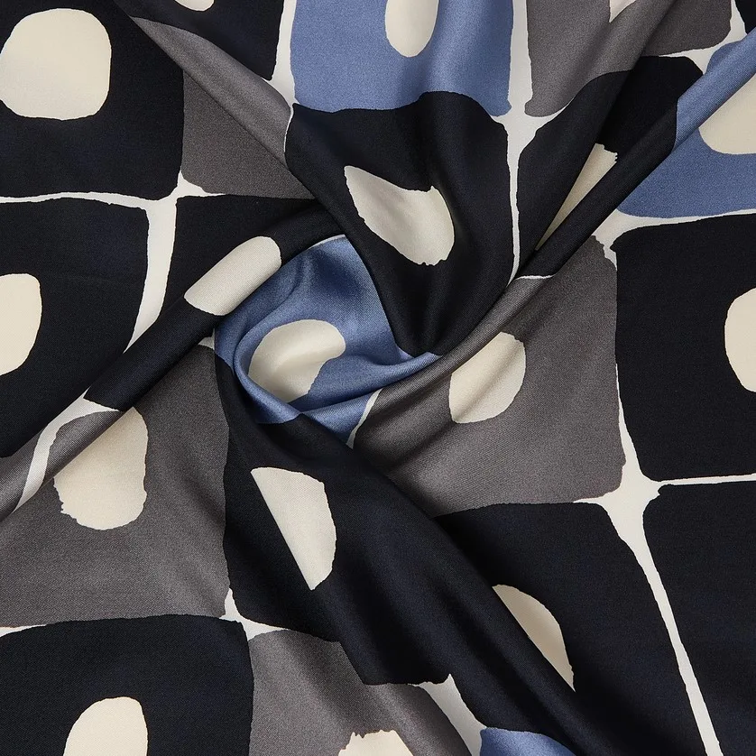 Detail view highlighting the smooth construction and luxurious drape of a custom silk scarf, ideal for private label fashion brands