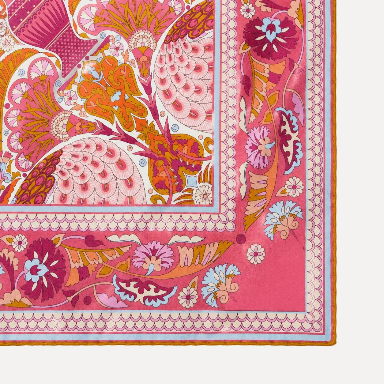 Detail view of a custom silk scarf design showcasing vibrant floral patterns with a bordered edge, tailored for private label fashion and gift brands