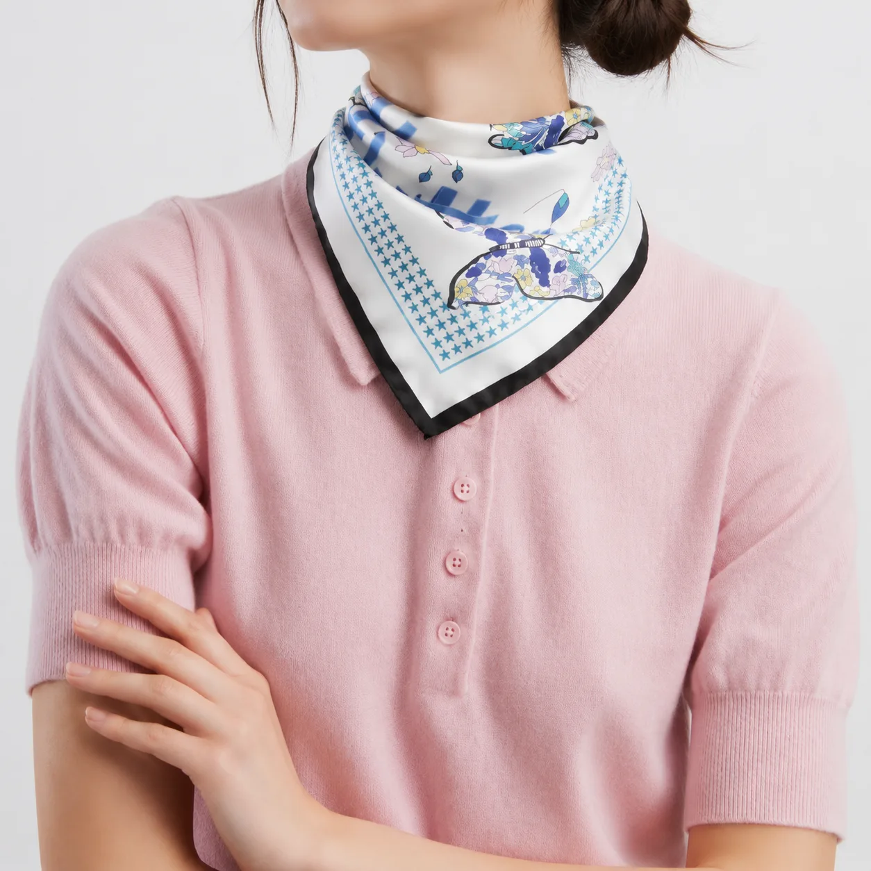 Detail view showcasing the construction of a custom silk scarf, featuring a stylish shape and precise edge finish, designed for optimal comfort and