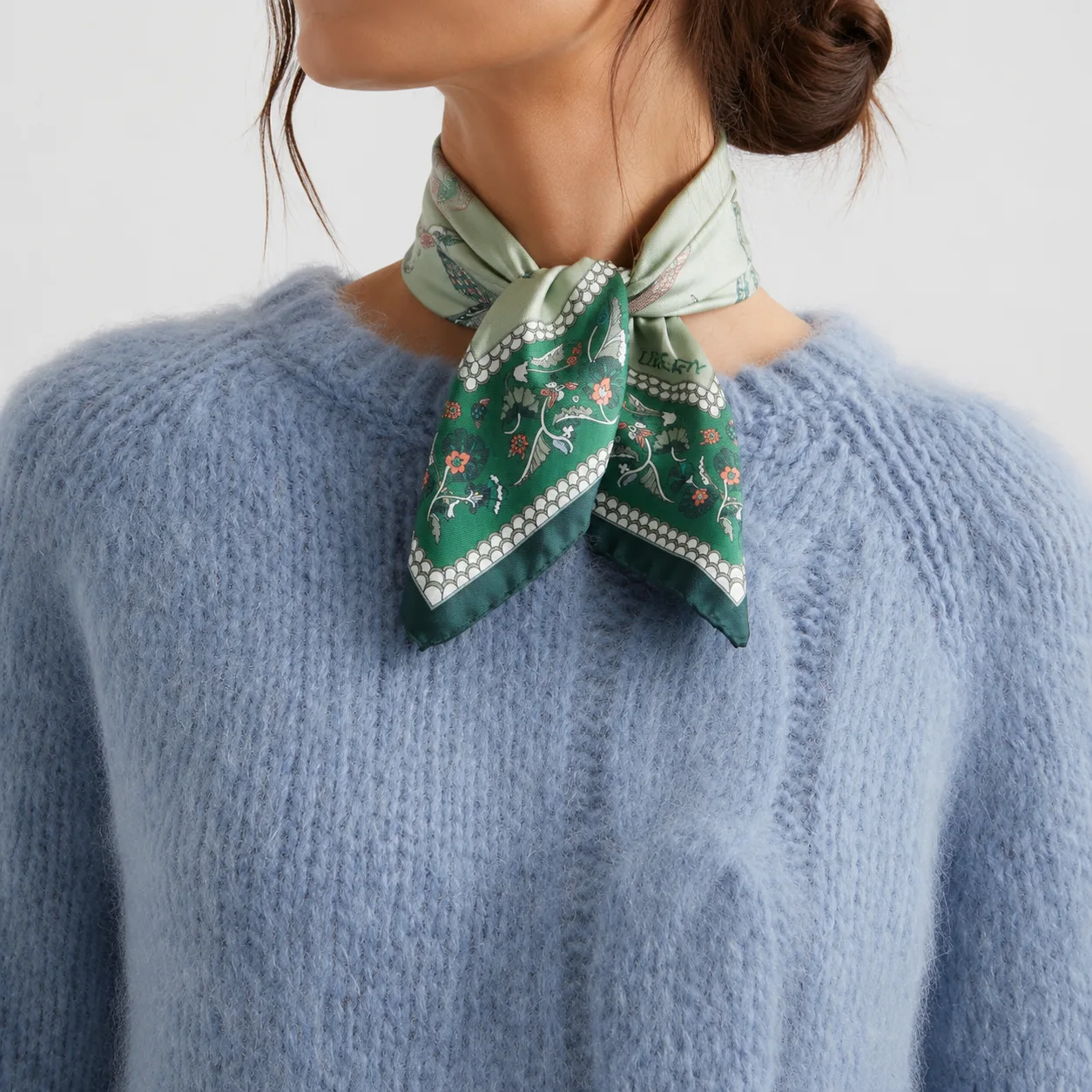 Detail view of a custom silk scarf featuring floral patterns, designed for private label fashion brands