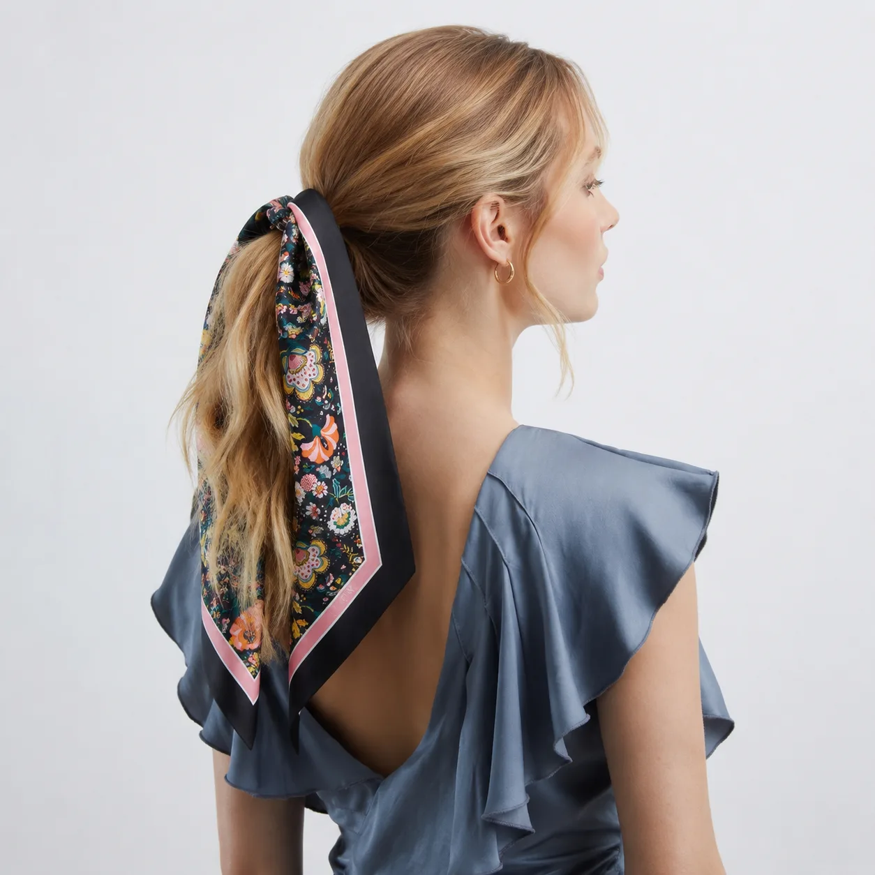 Detail view showcasing the structured shape and edge-finish of a custom silk scarf designed for private label fashion brands, featuring adjustable