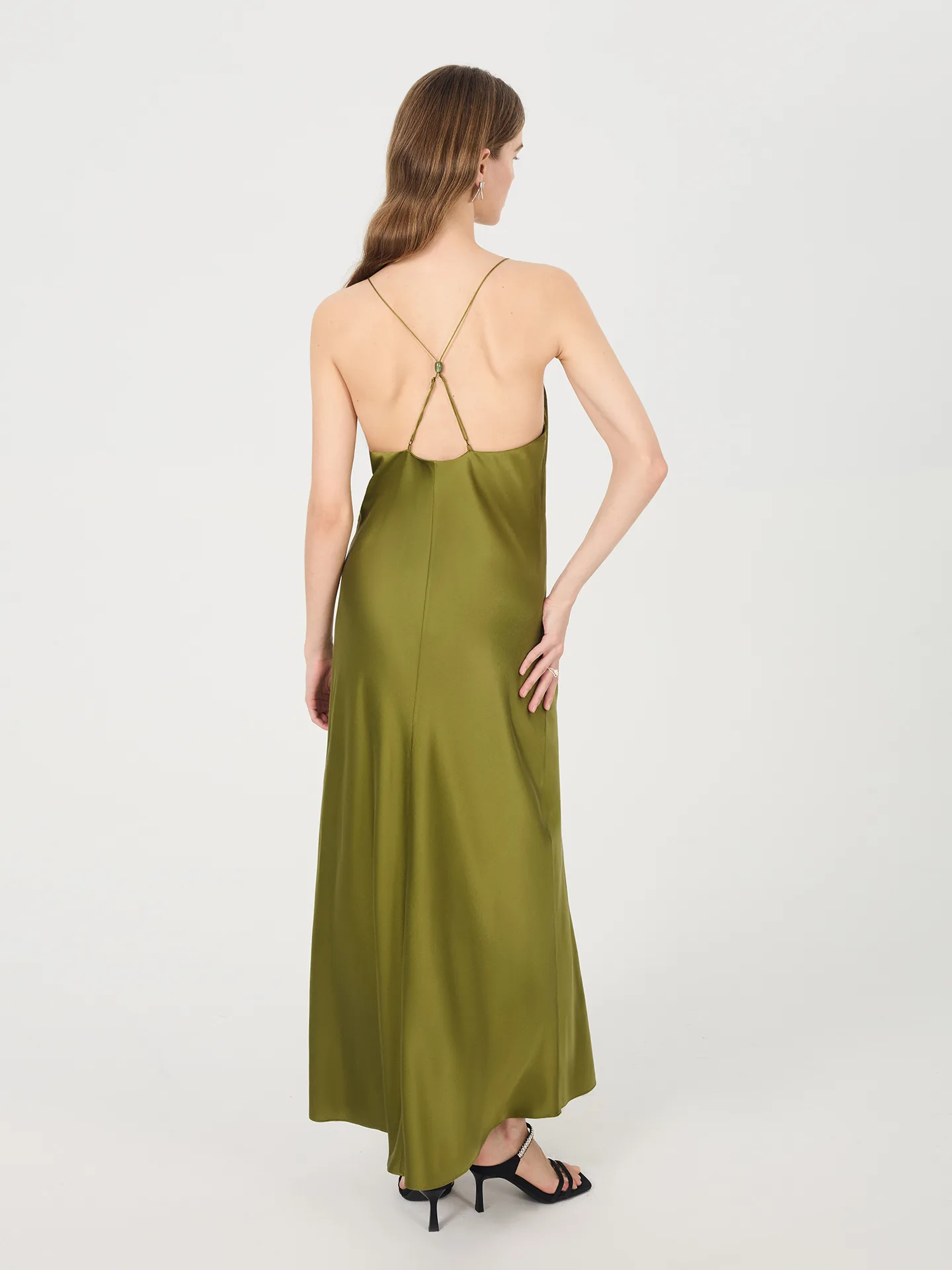 Detail view showcasing the elegant construction and fit of a custom silk dress with adjustable straps for private label clients