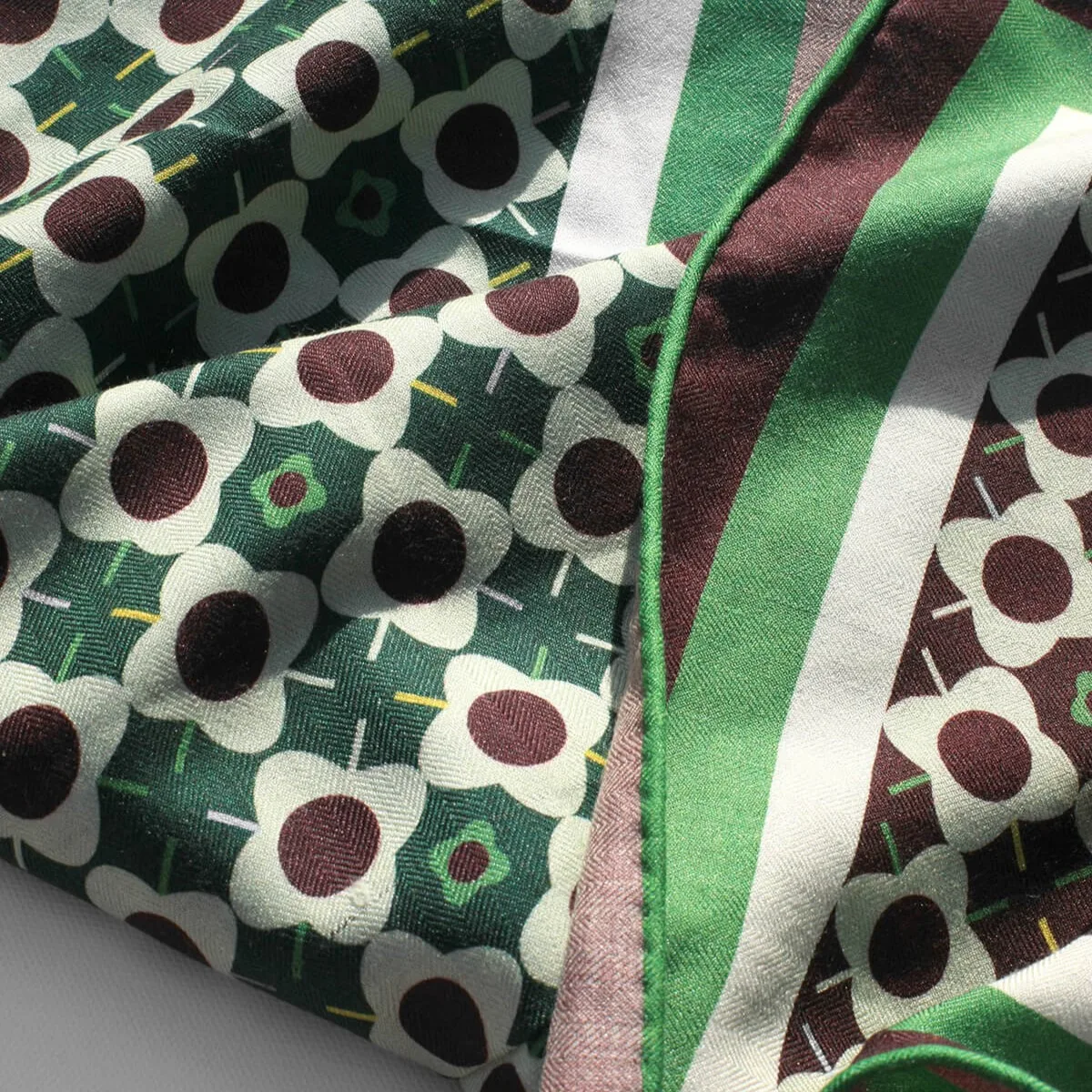 Detail view of custom silk scarf construction showcasing the floral pattern and edge finish for private label brands