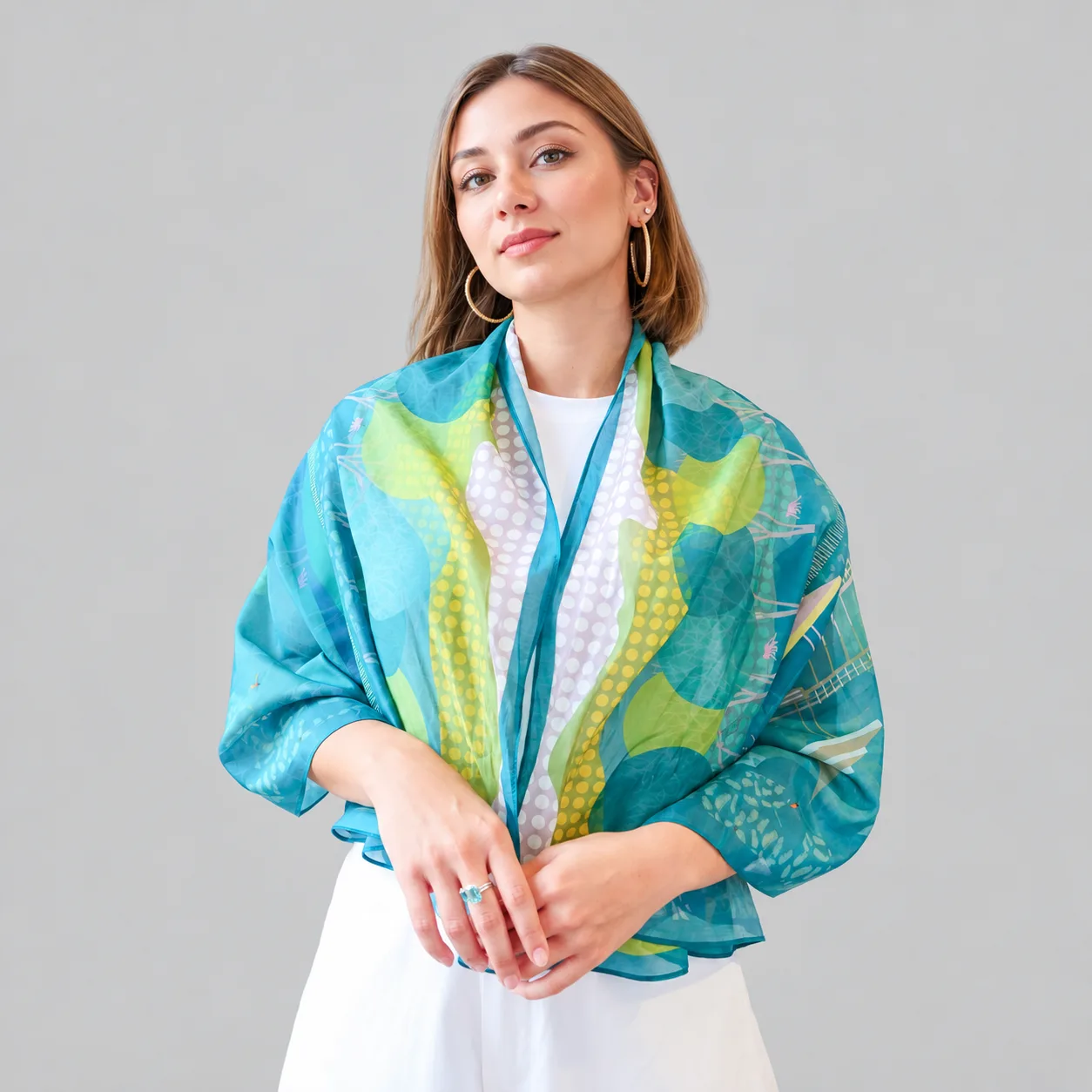 Detail view of a custom silk scarf featuring a flowing design, showcasing its lightweight construction and elegant drape, suitable for private label